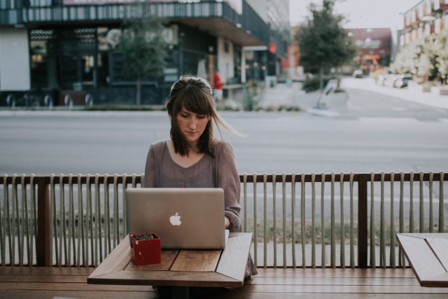 A young female student is studying at a cafe