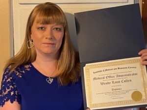 Wendy Cullen is holding her graduate diploma